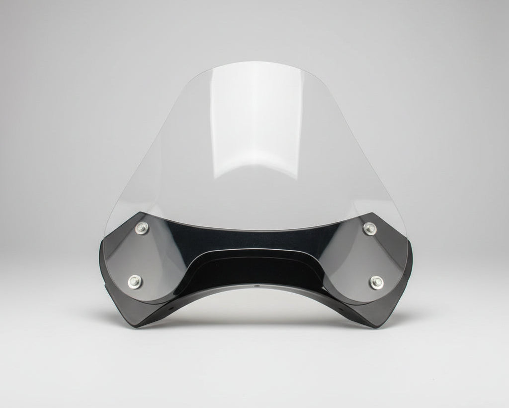 Clear protective face shield with black frame on a wooden surface, measured with a tape measure.
