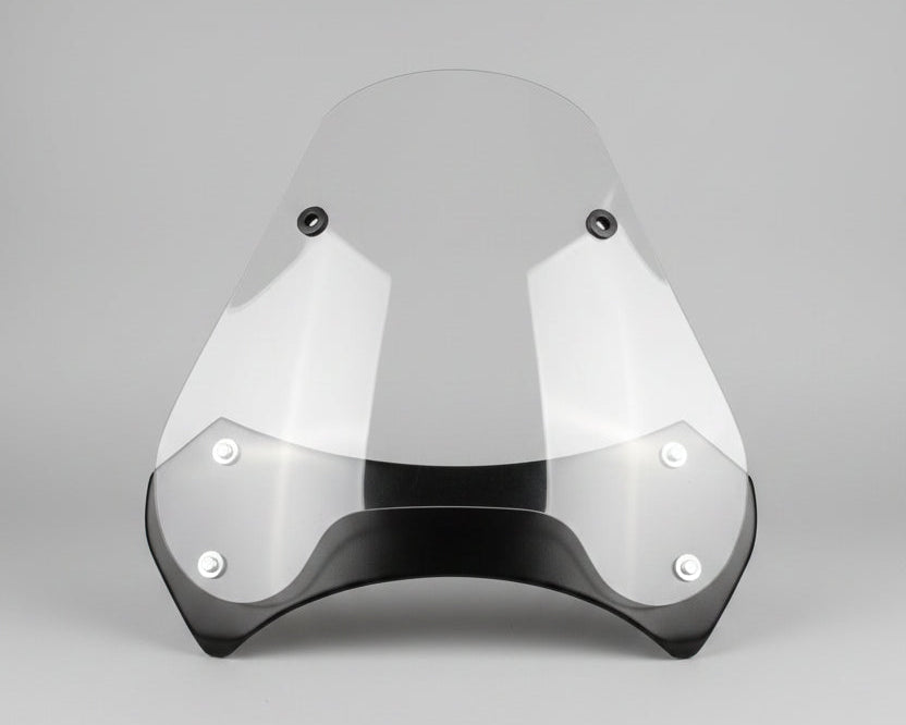 Clear protective visor with black frame on a wooden surface, measured with a tape measure.