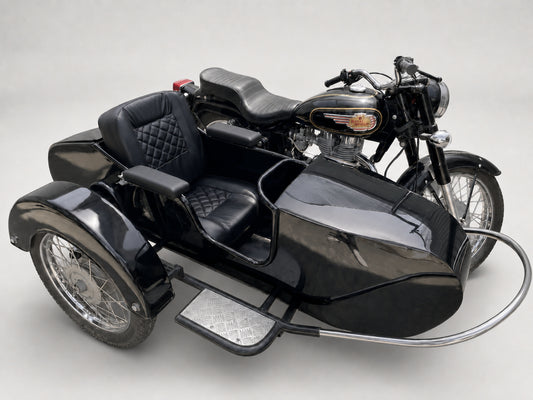 Black Royal Enfield motorcycle with Beemer passenger sidecar featuring black upholstered armrests.