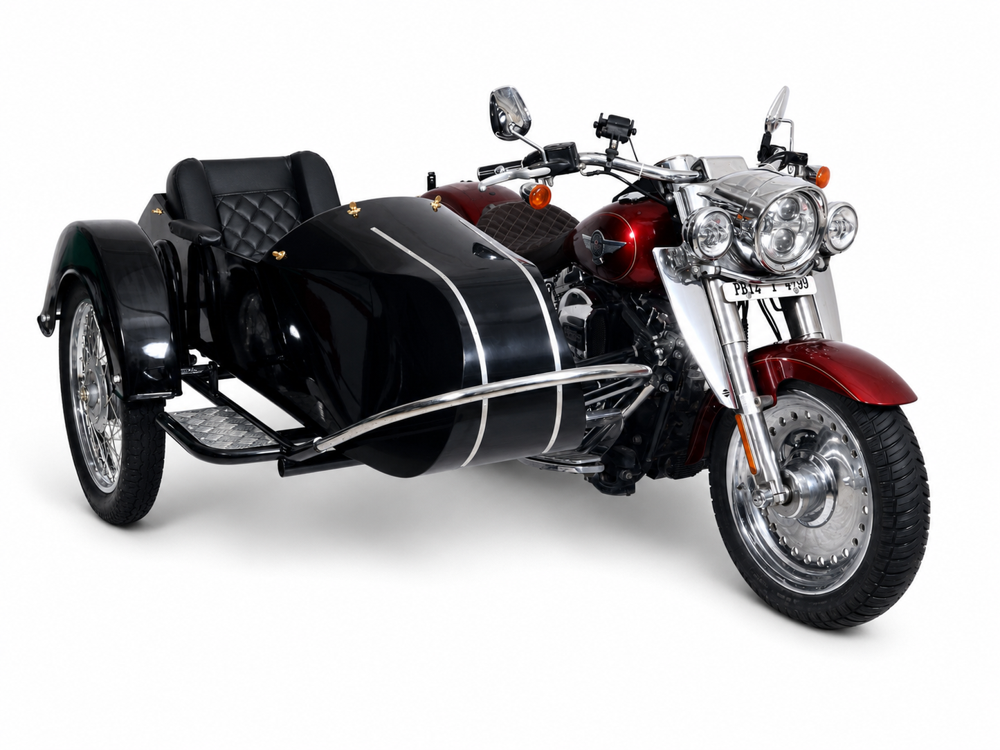 A black and red side-by-side motorcycle with a black sidecar, photographed on a clean white studio background.