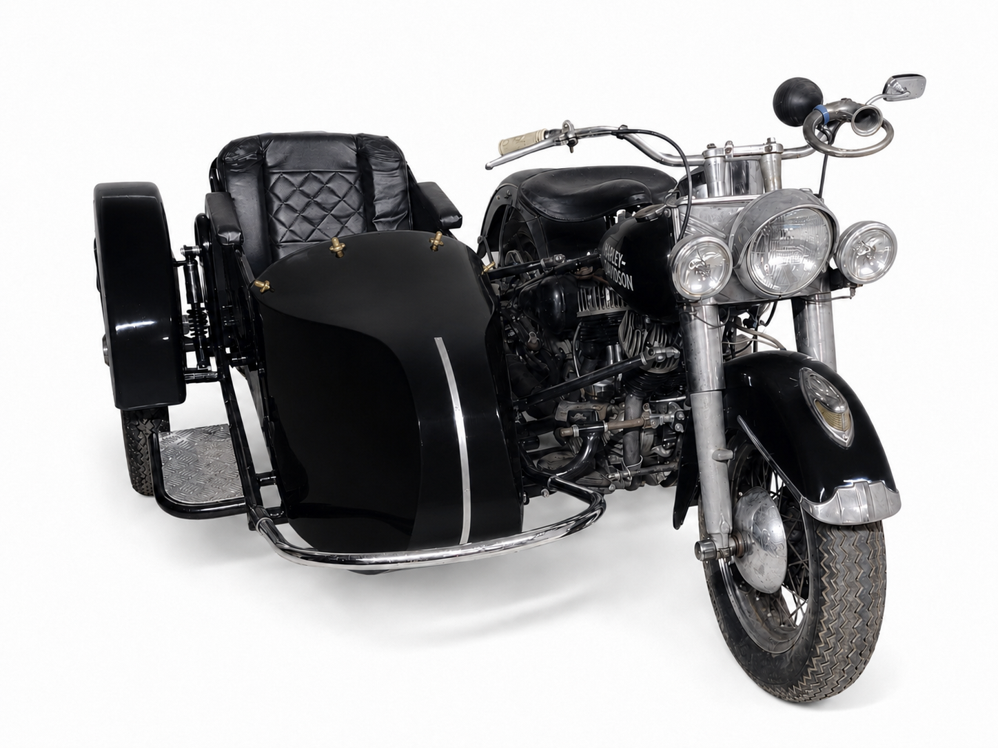Front three-quarter view of a black Retro passenger sidecar with black upholstery, color-matched to a black vintage Harley-Davidson motorcycle on a white background.