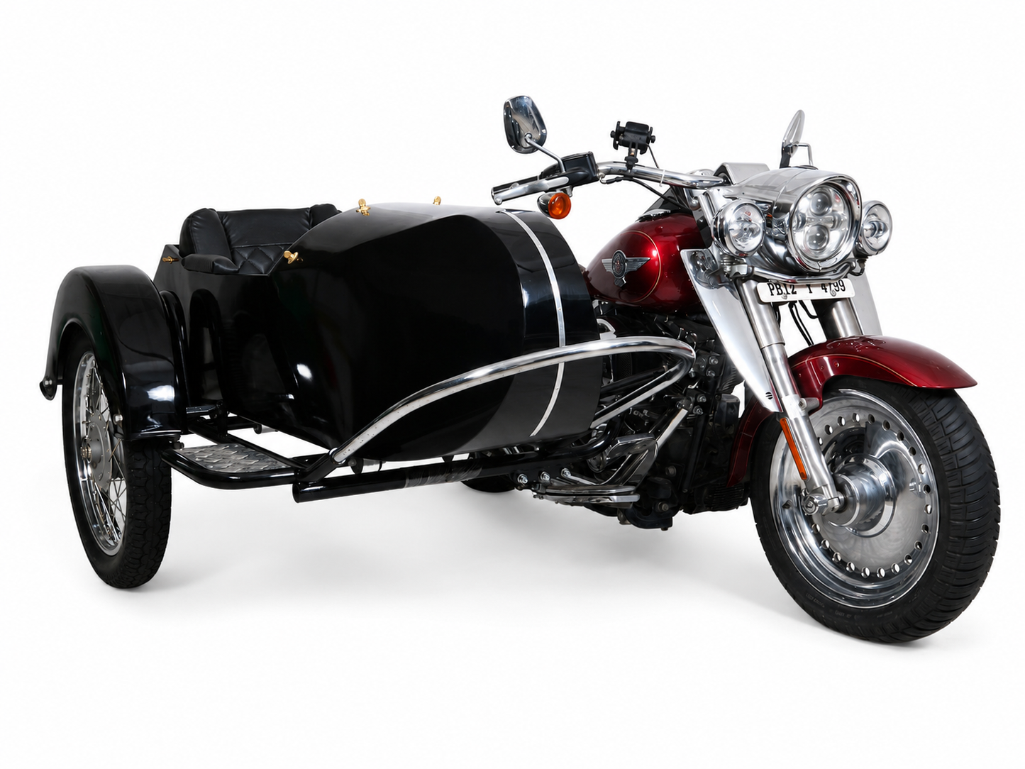 Front three-quarter view of a glossy black Retro passenger sidecar attached to a red cruiser motorcycle on a white background.