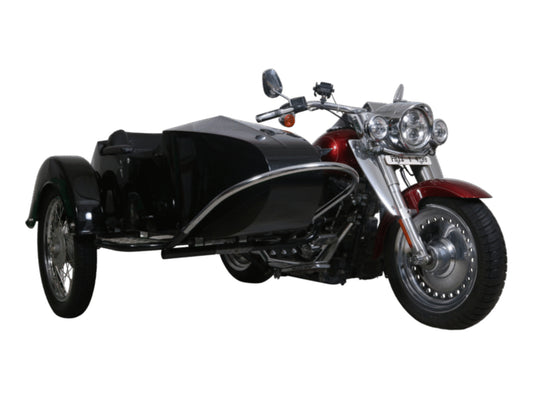 Front three-quarter view of a black Sam passenger sidecar installed on a red touring motorcycle, featuring black upholstery, a spoke sidecar wheel, chrome bumper rail, and mounting frame on white.