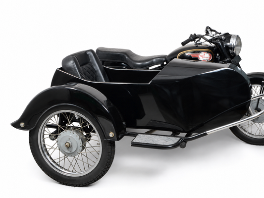 Side view of a black Vintage passenger sidecar attached to a Royal Enfield motorcycle on a white background.