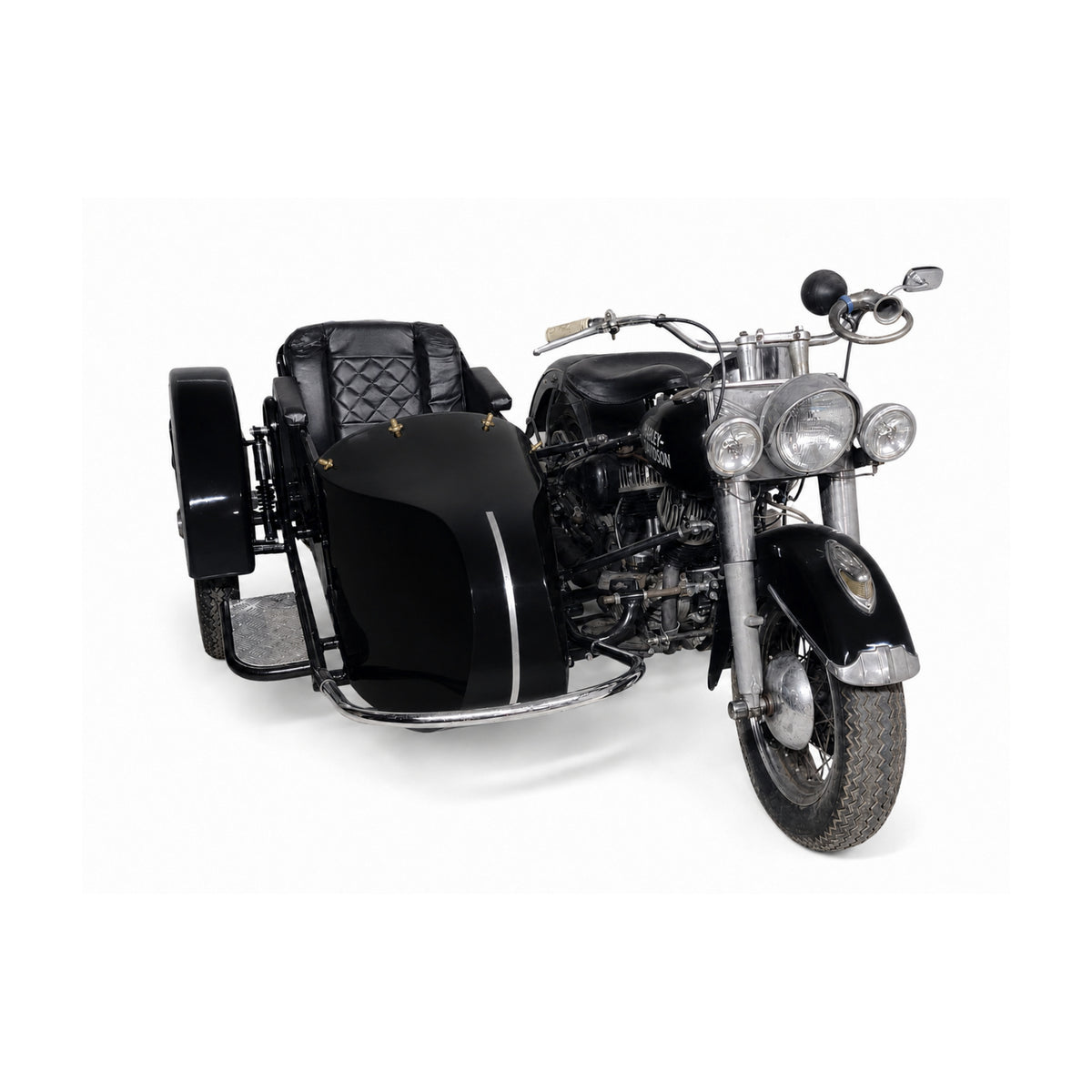 Front three-quarter view of a black Retro passenger sidecar with black upholstery, color-matched to a black vintage Harley-Davidson motorcycle on a white background.